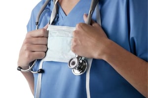 healthcare worker holding stethoscope around neck