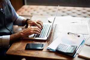 man typing on computer