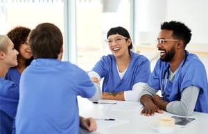 group of nurses sitting around a table