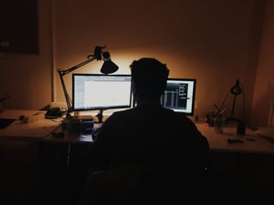 man sitting at computer
