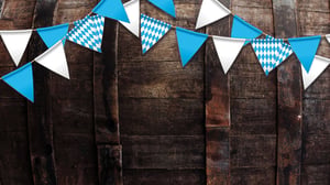 wooden barrel with Oktoberfest flags of teal and white