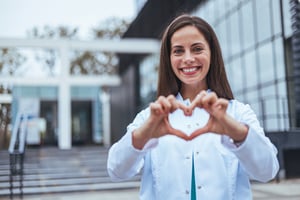 healthcare professional making heart with hands